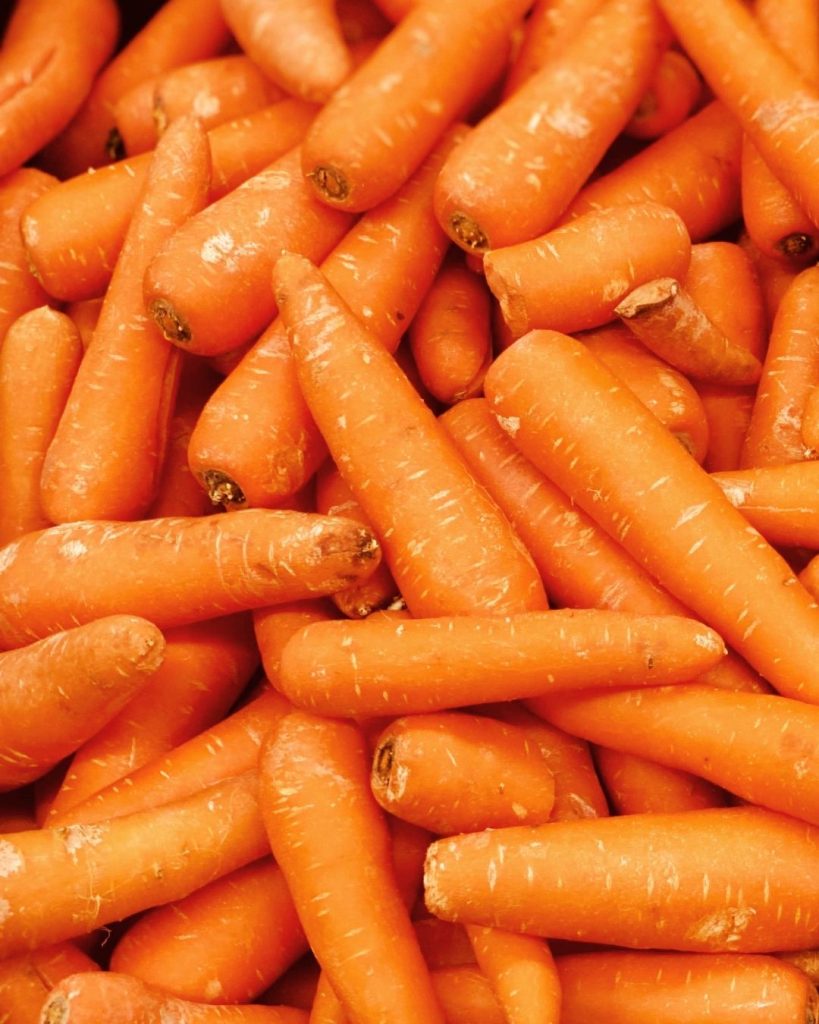 Pile of fresh orange carrots representing rescued surplus produce