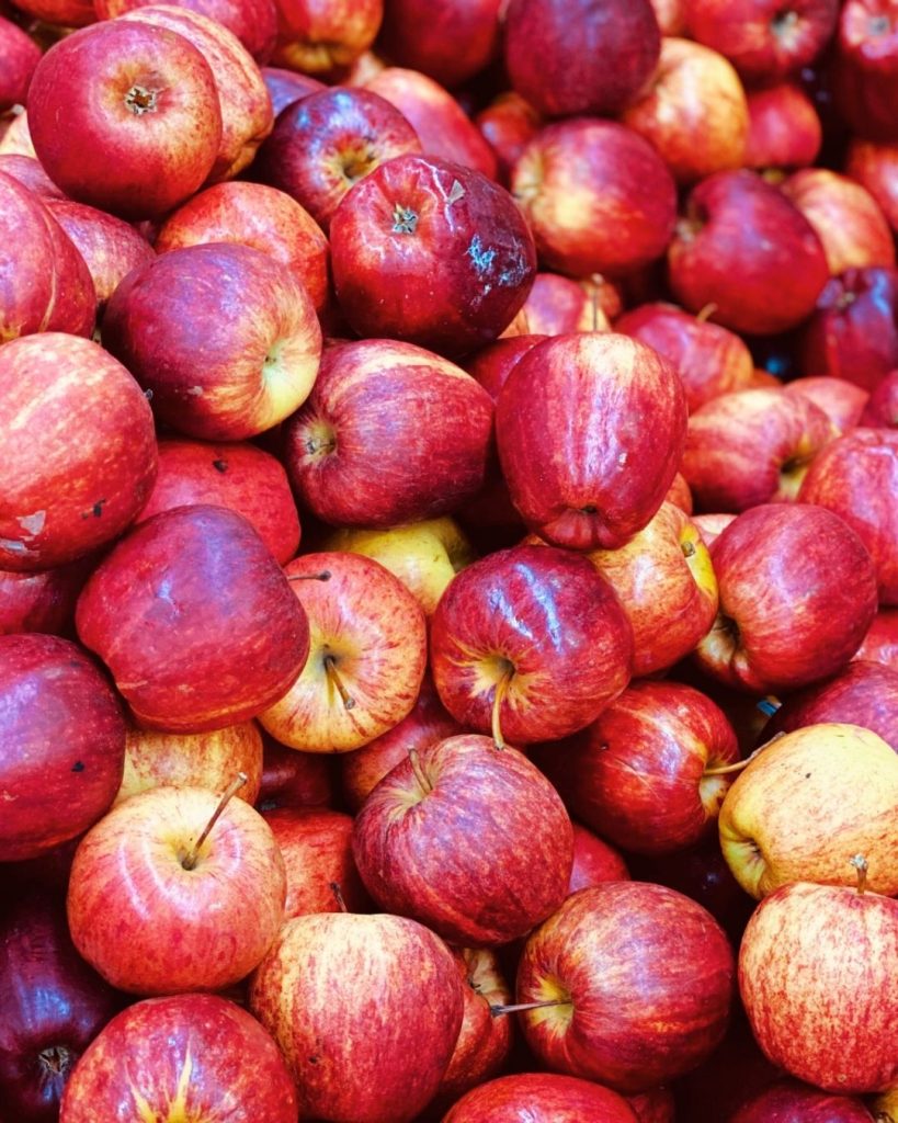 Pile of fresh red and yellow apples representing rescued surplus produce